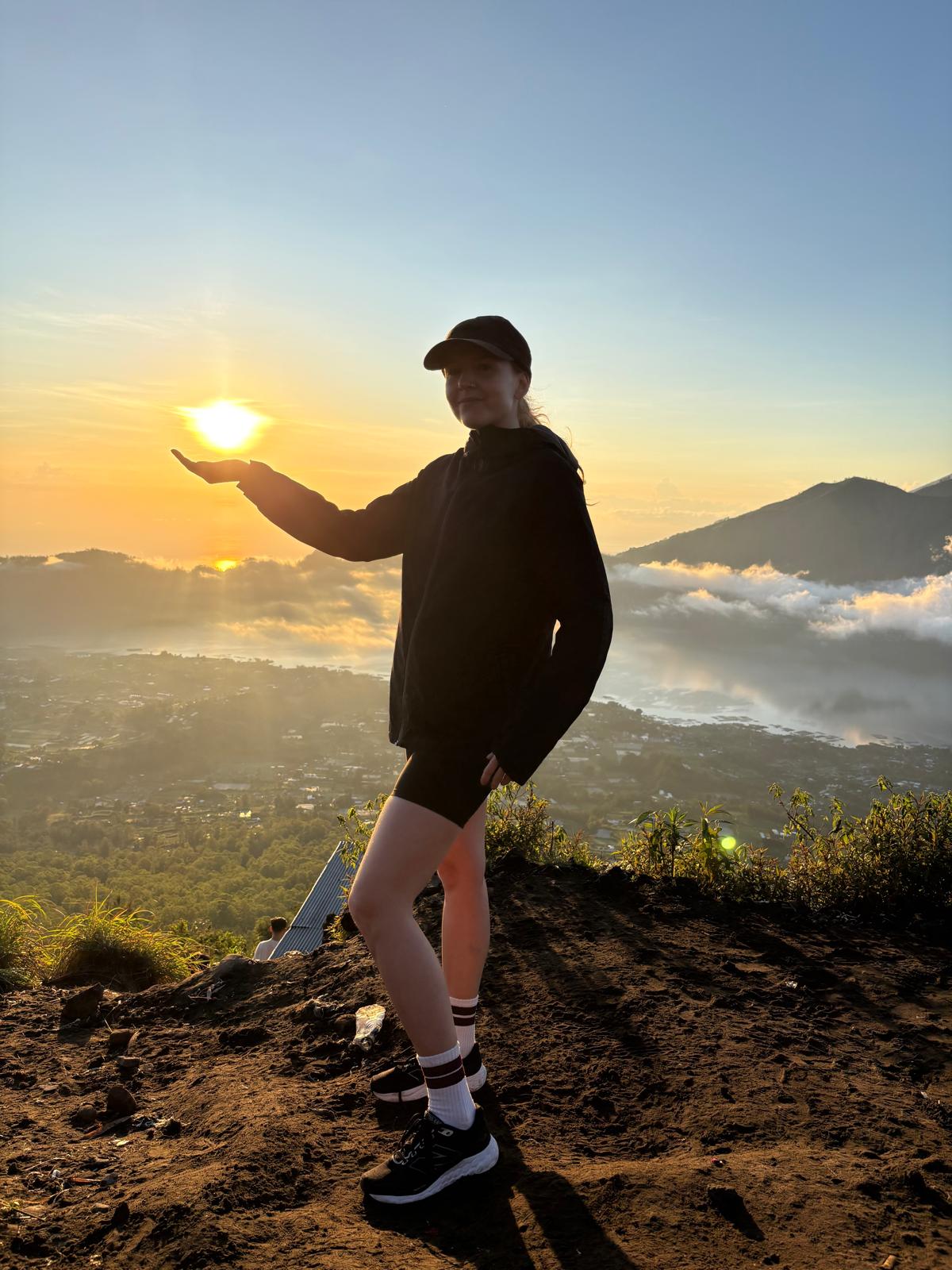 Traveler enjoying sunrise from Mount Batur